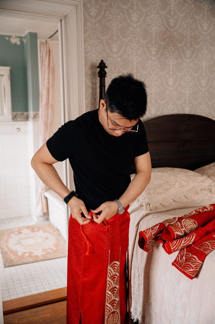 groom putting on his traditional chinese garments