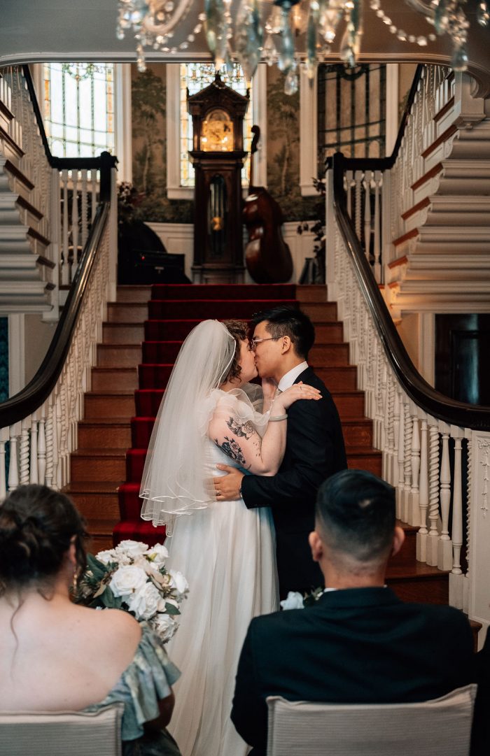 bride and groom kiss during ceremony