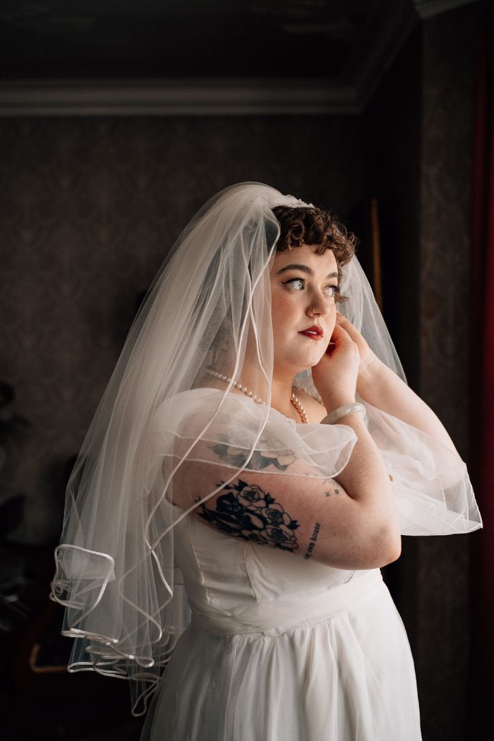 bride in a vintage wedding dress and 80s vintage veil