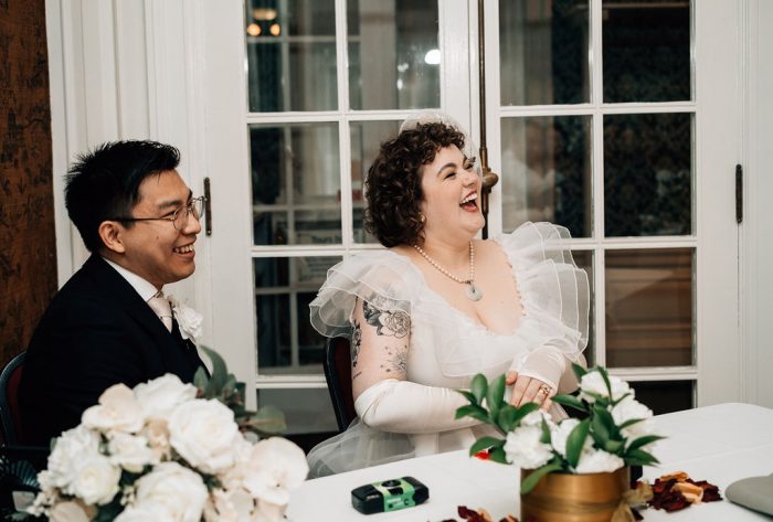 bride and groom listening to speeches 